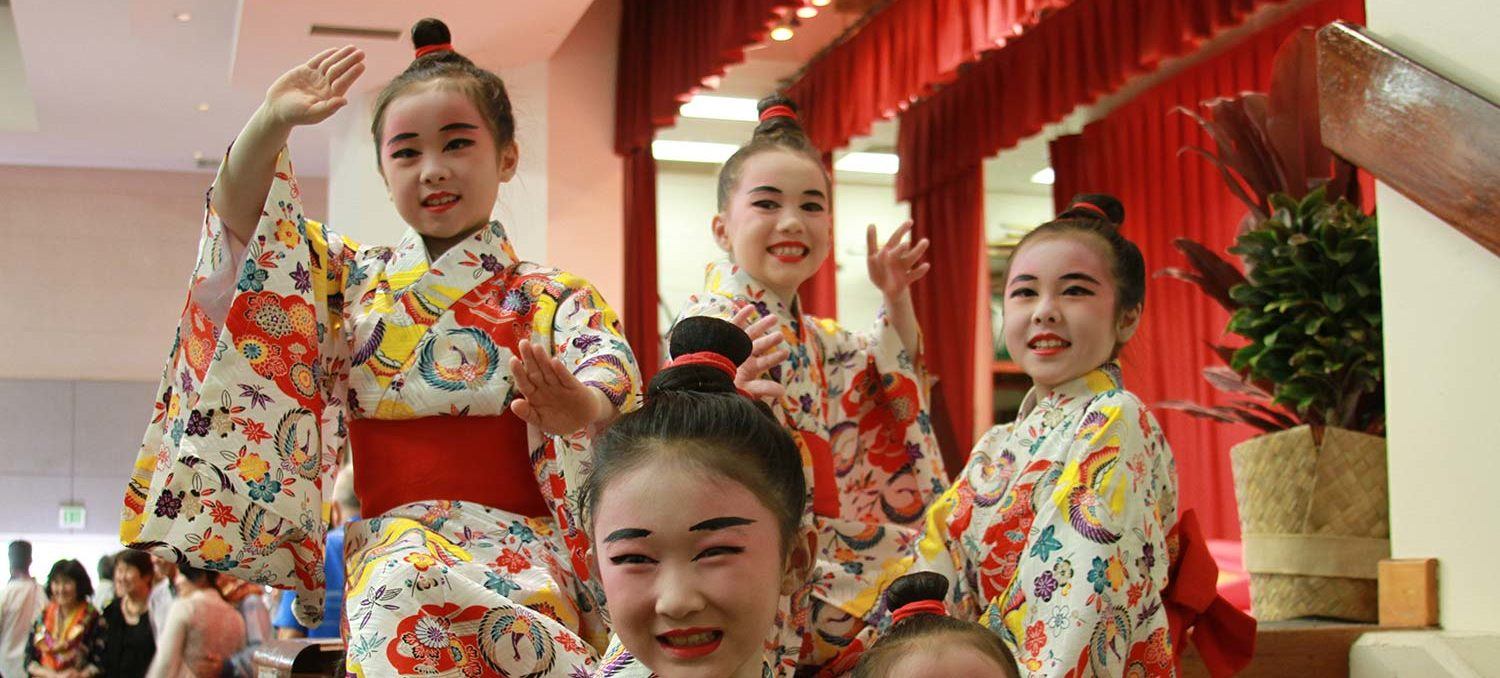 Tamagusuku Ryu Senju Kai Hawaii classes feature photo of girls smiling for the camera in Okinawan costume